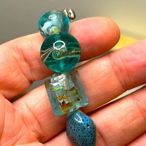 Bracelet with blue, teal beads, turtle, fish